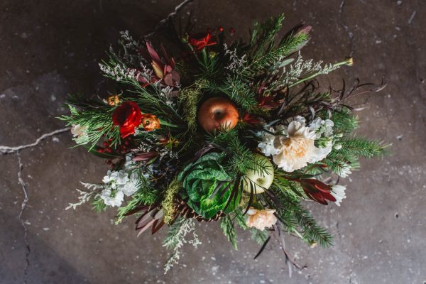christmas centerpieces with pine, cedar, cabbage, red berries, and bay leaves