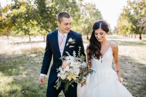 bride-walking-with-dahlia-bridal-boquet