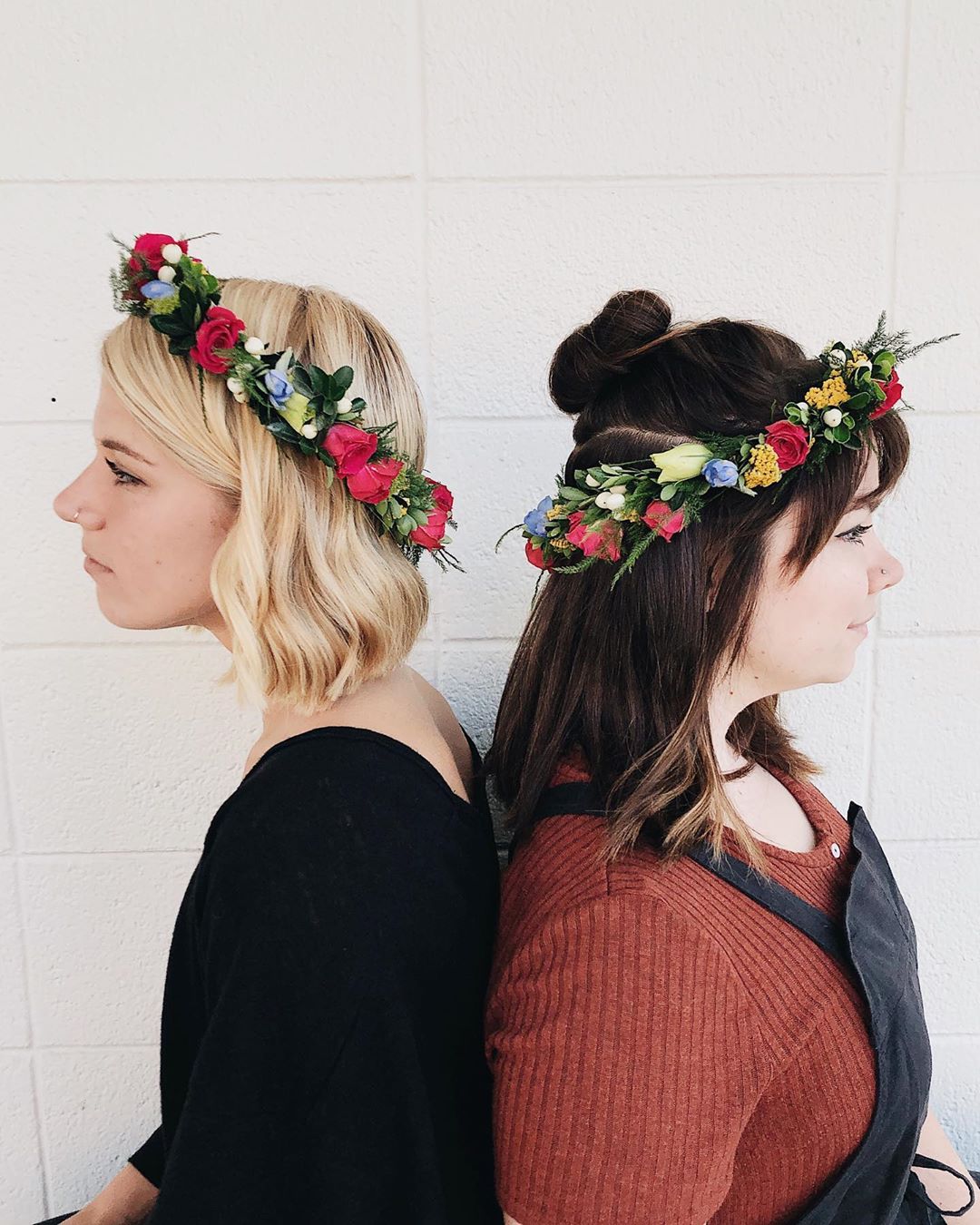 two girls wearing flower crowns