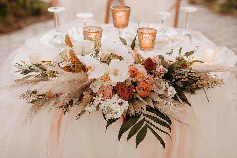 fall bridal bouquet laying on wedding reception table as centerpiece